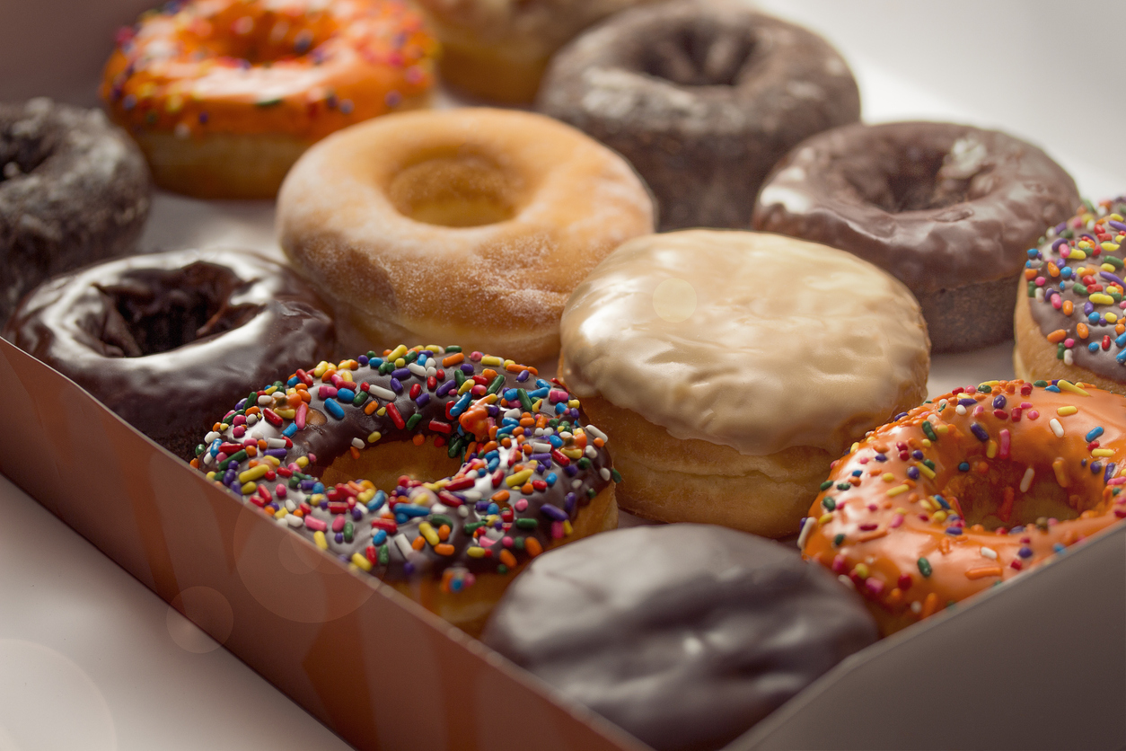 A clean image of twelve donuts in a box, ready to take to the office meeting or breakfast with the family.