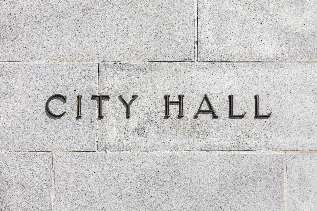 City Hall sign on a stone cold granite wall.