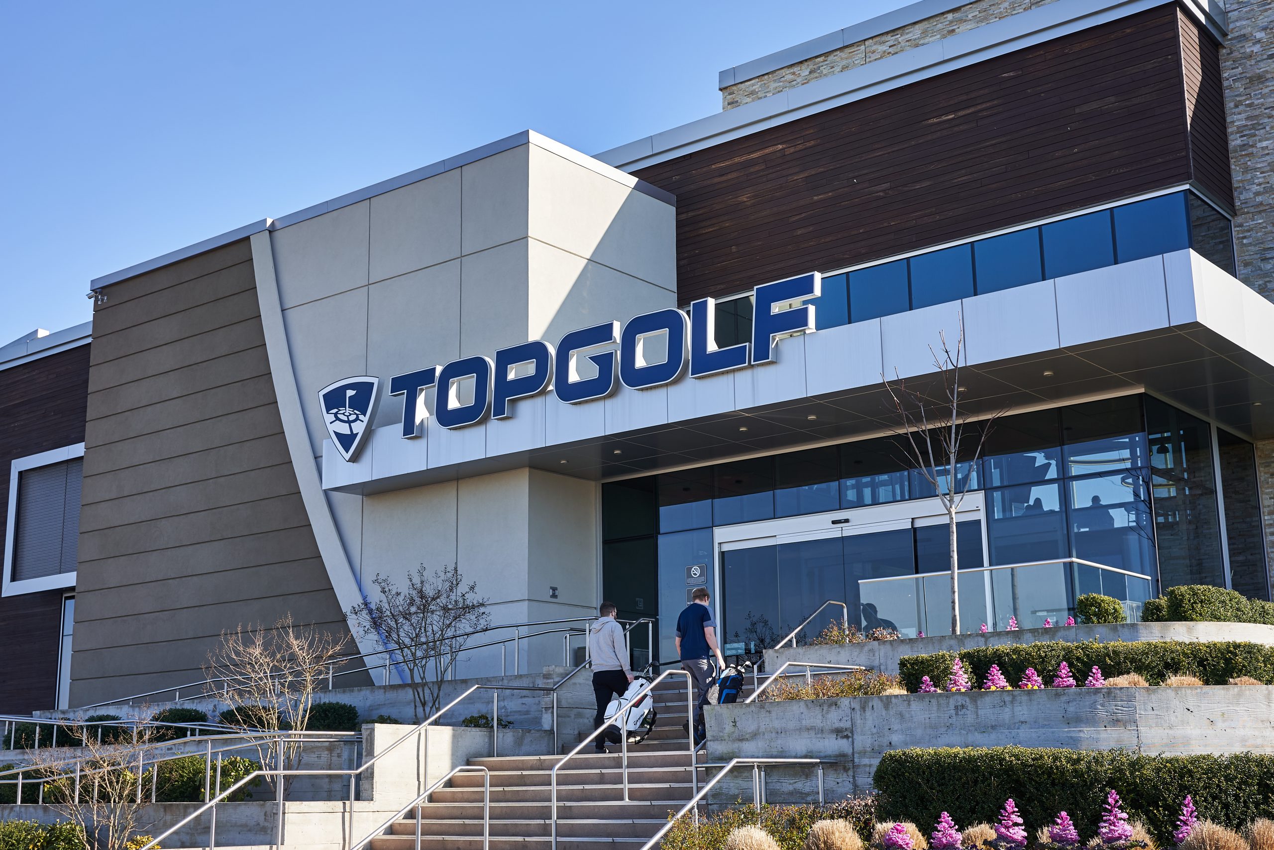 Hillsboro, OR, USA - Feb 21, 2020: Golfers entering a branch on the sports entertainment company Topgolf International's driving-range chain in Hillsboro, a suburb within the Portland metro area in Oregon.