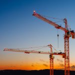 Construction cranes representing healthcare growth and development in Northwest Arkansas