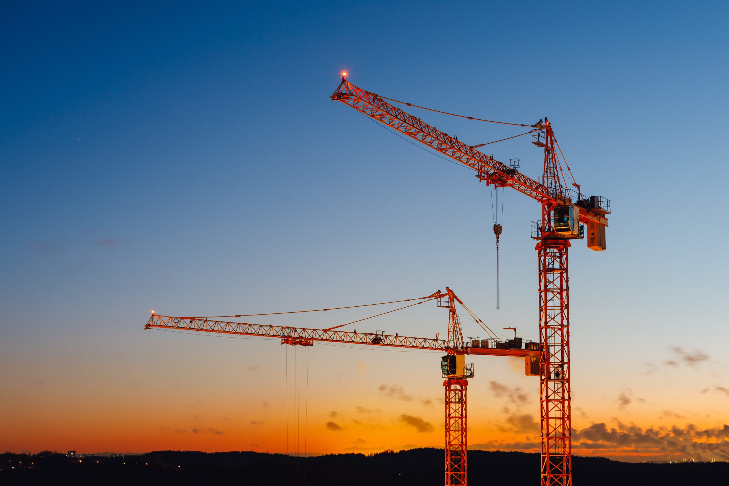 Construction cranes representing healthcare growth and development in Northwest Arkansas